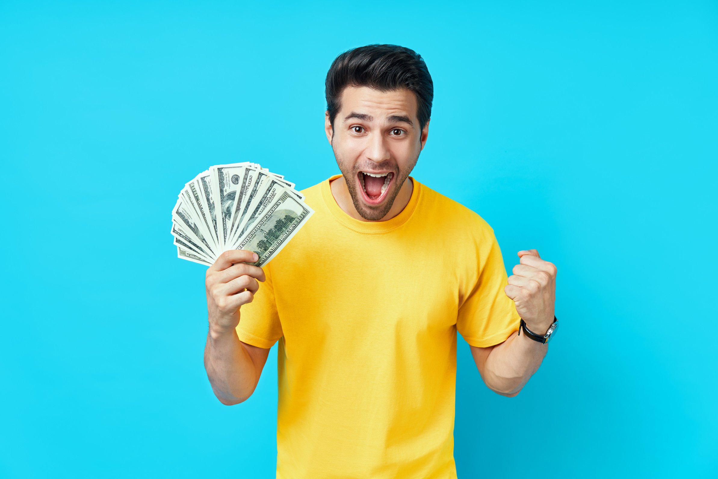 Happy and  Excited Man Showing Money Banknotes on Blue Background